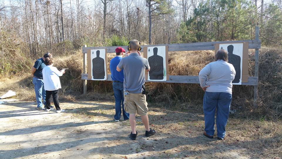 Instructor coaching students at the target line